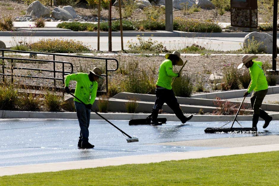 A professional cleaning crew in protective gear cleaning up a post-construction site